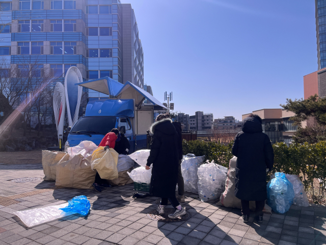 서울 광진구 중곡역 인근 한 공원에서 작업자들이 네프론으로 수거된 재활용품을 운반하고 있다. 마가연 견습기자