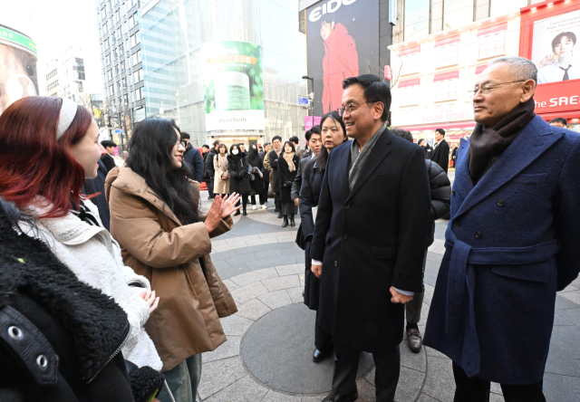 최상목 대통령 권한대행 부총리 겸 기획재정부 장관과 유인촌 문화체육관광부 장관이 2월 21일 서울 중구 명동예술극장 앞에 마련된 코리아그랜드세일 웰컴센터에서 외국인 관광객들과 대화하고 있다. 사진 제공=기재부