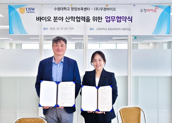 천희정(오른쪽) 우정바이오 미래전략기획실장이이달 7일 수원대와 업무협약을 맺고 기념 촬영을 하고 있다. 사진 제공=우정바이오
