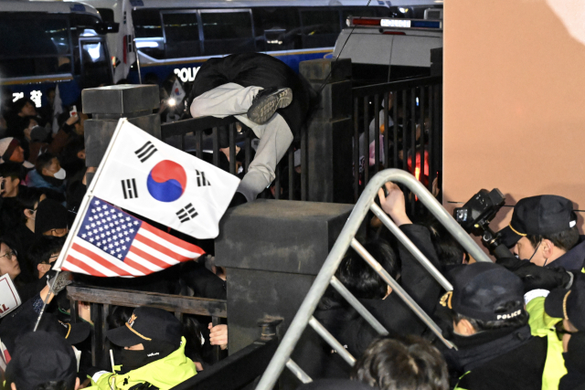 내란 우두머리 혐의로 체포된 윤석열 대통령의 영장실질심사가 열린 1월 18일 오후 서울 마포구 서울서부지방법원에서 윤 대통령 지지자들이 법원 담장을 넘고 있다. 뉴스1