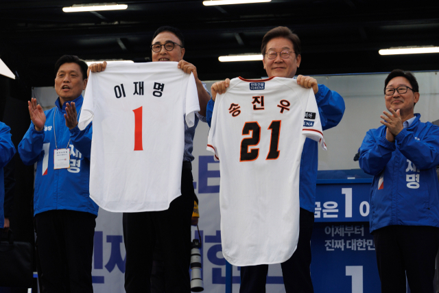 이재명 더불어민주당 대선 후보가 31일 대전 서구 보라매공원에서 진행된 유세에서 프로야구 한화이글스의 영구 결번(등번호 21) 선수로 남은 송진우 선수에게 받은 유니폼을 들어보이고 있다. 송 선수는 이 후보에게 ‘21대 대통령이 되길 바란다며’ 유니폼을 선물했다. 대전=오승현 기자 2025.05.31