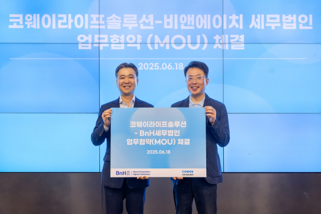 김명곤(오른쪽) 코웨이라이프솔루션 대표이사와 이명수 BnH세무법인 부대표가 18일 서울 구로구 지타워 코웨이라이프솔루션 본사에서 열린 협약식에서 기념 촬영을 하고 있다. 사진제공=코웨이