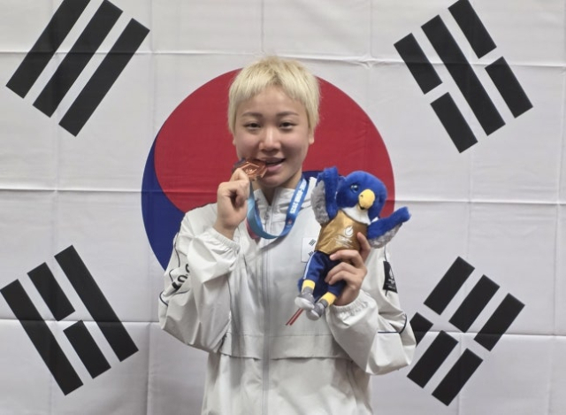 독일 라인-루르 하계U대회에서 딴 동메달을 깨물어보는 이은지. 사진 제공=대한수영연맹