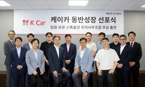 정인국(왼쪽 여섯 번째) 케이카 사장이 박창현(왼쪽 일곱 번째) 케이카 우리사주 조합장과 28일 동반성장 선포식을 진행한 후 임직원들과 기념촬영을 하고 있다. 사진제공=케이카