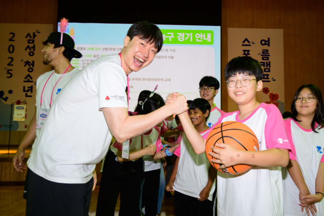 제일기획이 7일 경기 고양시 삼성화재 글로벌캠퍼스 다목적홀에서 개최한 ‘제2회 삼성 다문화 청소년 스포츠 클래스 여름 캠프’에서 삼성 썬더스 농구단 최성모(왼쪽) 선수와 참가 학생이 손을 맞잡고 파이팅을 외치고 있다. 사진 제공=제일기획