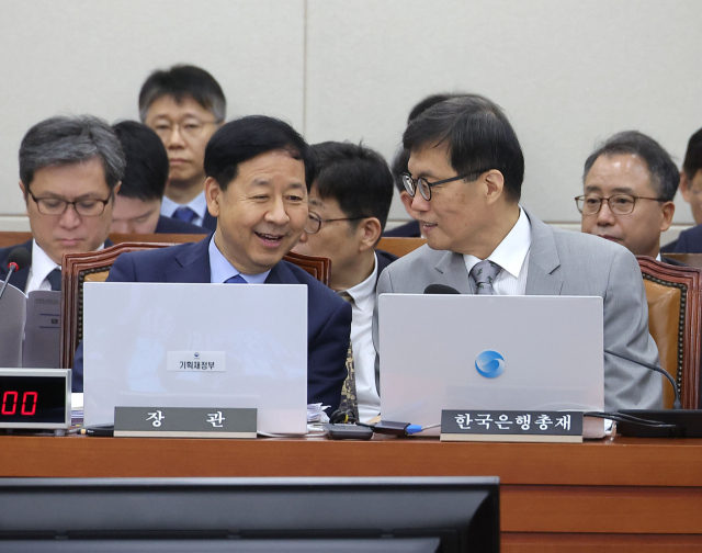 구윤철 경제부총리 겸 기획재정부 장관(왼쪽)과 이창용 한국은행 총재가 19일 국회에서 열린 기획재정위원회 전체회의에 참석해 대화를 나누고 있다. 연합뉴스.