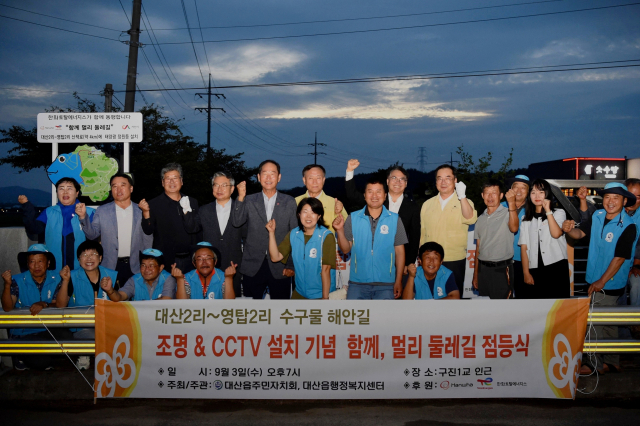 한화토탈에너지스가 3일 대산읍 수구물로 해안 산책로에서 ‘함께, 멀리 둘레길’ 점등식을 개최한 가운데 지역 관계자들과 회사 임직원이 점등을 축하하고 있다. 사진 제공=한화토탈에너지스