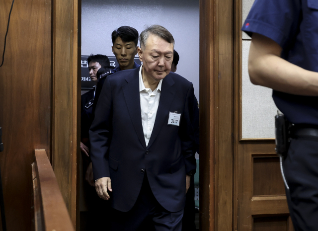 윤석열 전 대통령이 26일 서울 서초구 서울중앙지법에서 열린 특수공무집행방해, 직권남용 권리행사방해 등 혐의 사건 1차 공판에 출석하고 있다. 사진공동취재단
