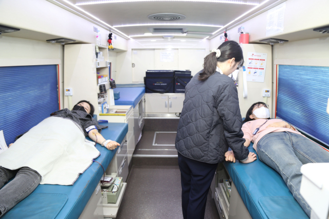 DL그룹 직원들이 서울 마곡동 본사에 배치된 헌혈 버스에서 헌혈을 하고 있다. 사진 제공=DL