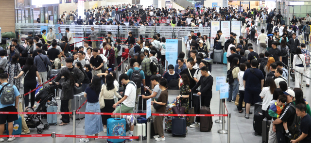 2일 오전 부산 강서구 김해국제공항 국제선 출국장에서 추석 연휴를 이용해 해외여행을 떠나는 여행객들이 길게 줄을 선 채 출국수속을 기다리고 있다. 한국공항공사 부산본부에 따르면, 추석 연휴인 오는 3일부터 12일까지 10일 동안 32만 9930명이 김해국제공항 국제선을 이용할 것으로 예상된다. 부산=연합뉴스