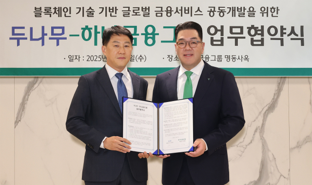 하나금융그룹이 이달 3일 오후 두나무와 블록체인 기술을 활용한 금융 서비스 공동 개발을 위한 업무협약을 체결했다.이날 협약식에 참석한 이은형(오른쪽) 하나금융그룹 부회장이 오경석 두나무 대표이사와 함께 협약서를 들고 기념 촬영을 하고 있다.