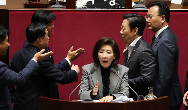 9일 국회 본회의에서 나경원(가운데) 국민의힘 의원이 ‘가맹사업거래의 공정화에 관한 법률 일부개정법률안’에 대해 필리버스터(무제한 토론)를 하는 가운데 여야 의원들이 발언대에서 목소리를 높이며 신경전을 이어가고 있다. 연합뉴스